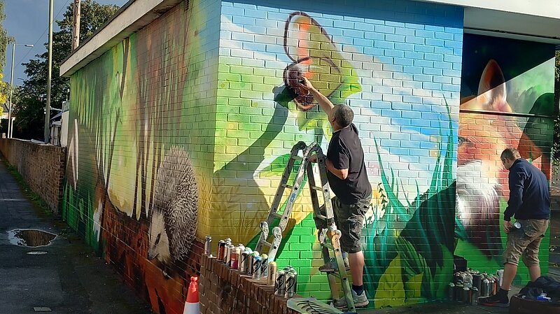 Mural being painted at the Upper High Street Car Park